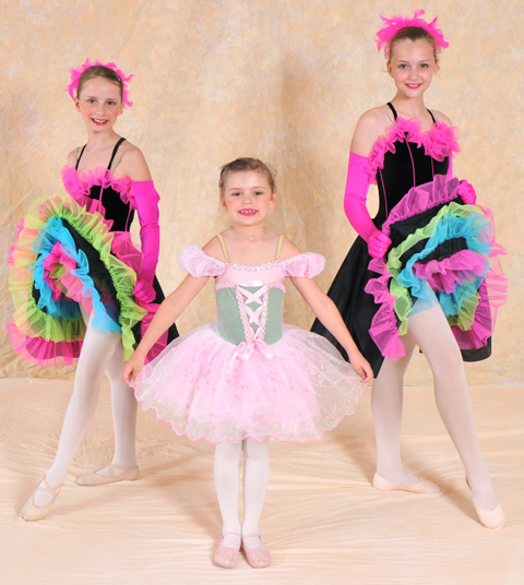 Three girls posing in ballet costumes